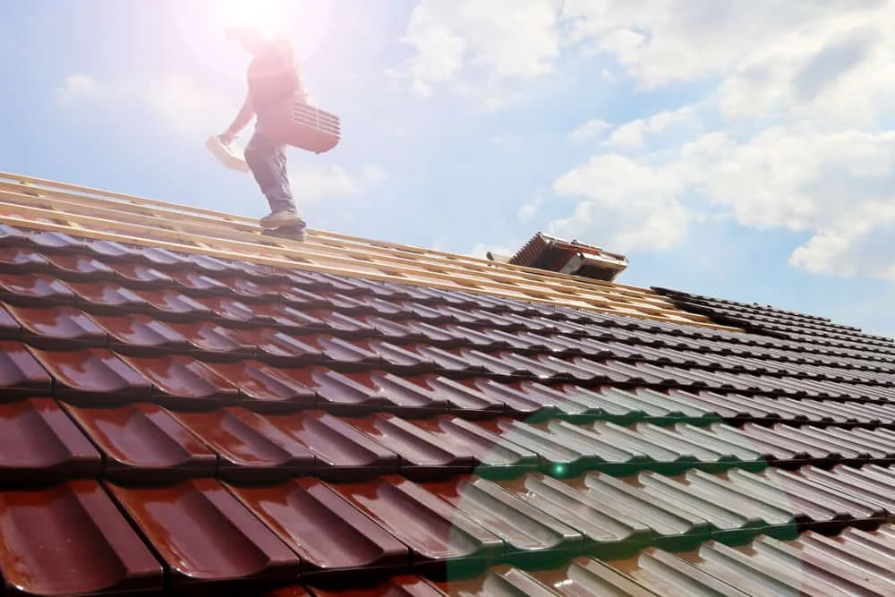 worker standing on a metal roofing